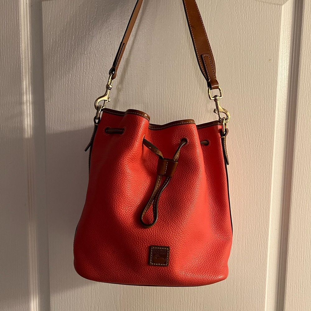 This beautiful orange Dooney and Bourke shoulder bag